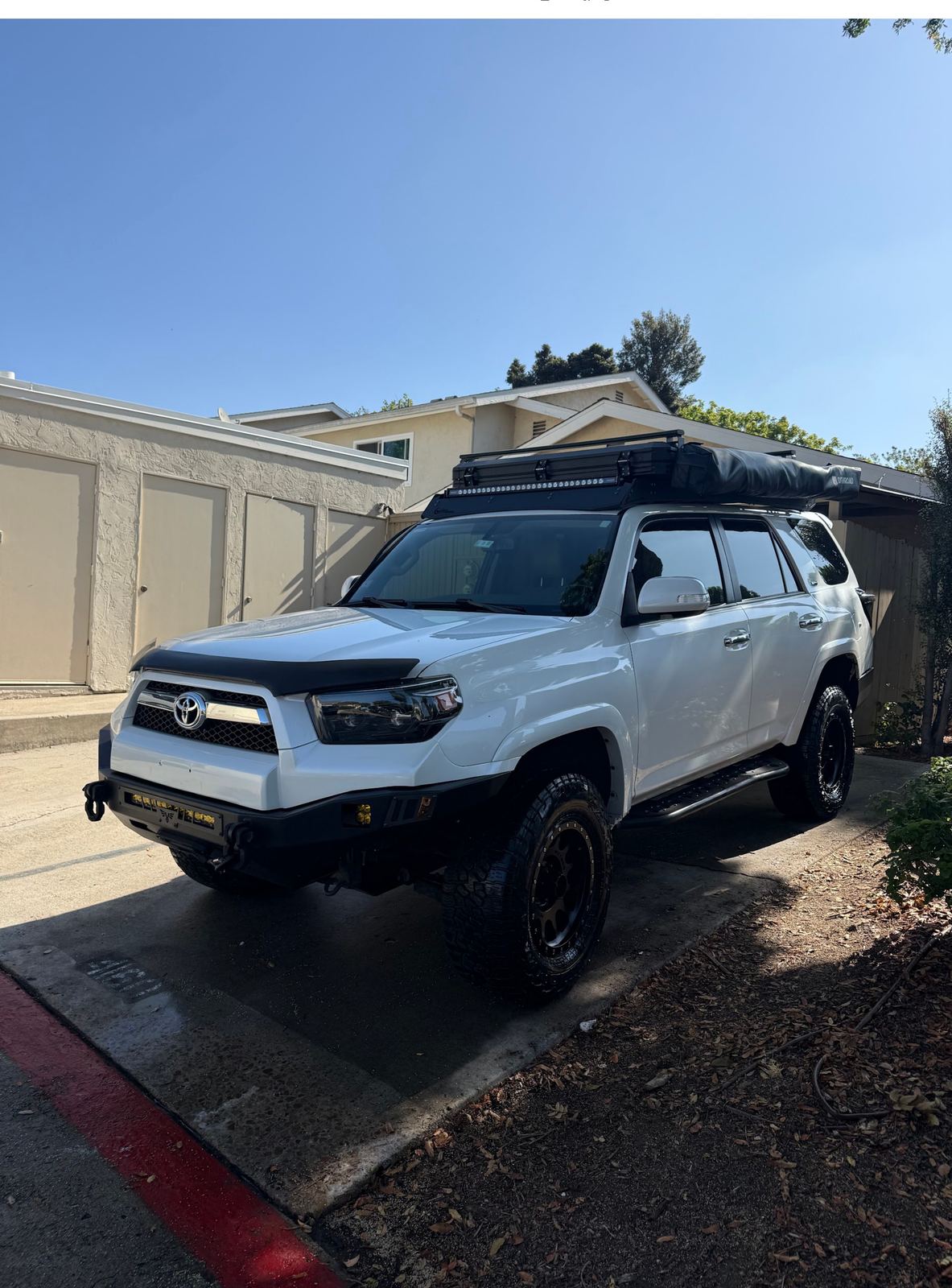 Detailed white lifted Toyota 4Runner with roof rack, mobile detailing