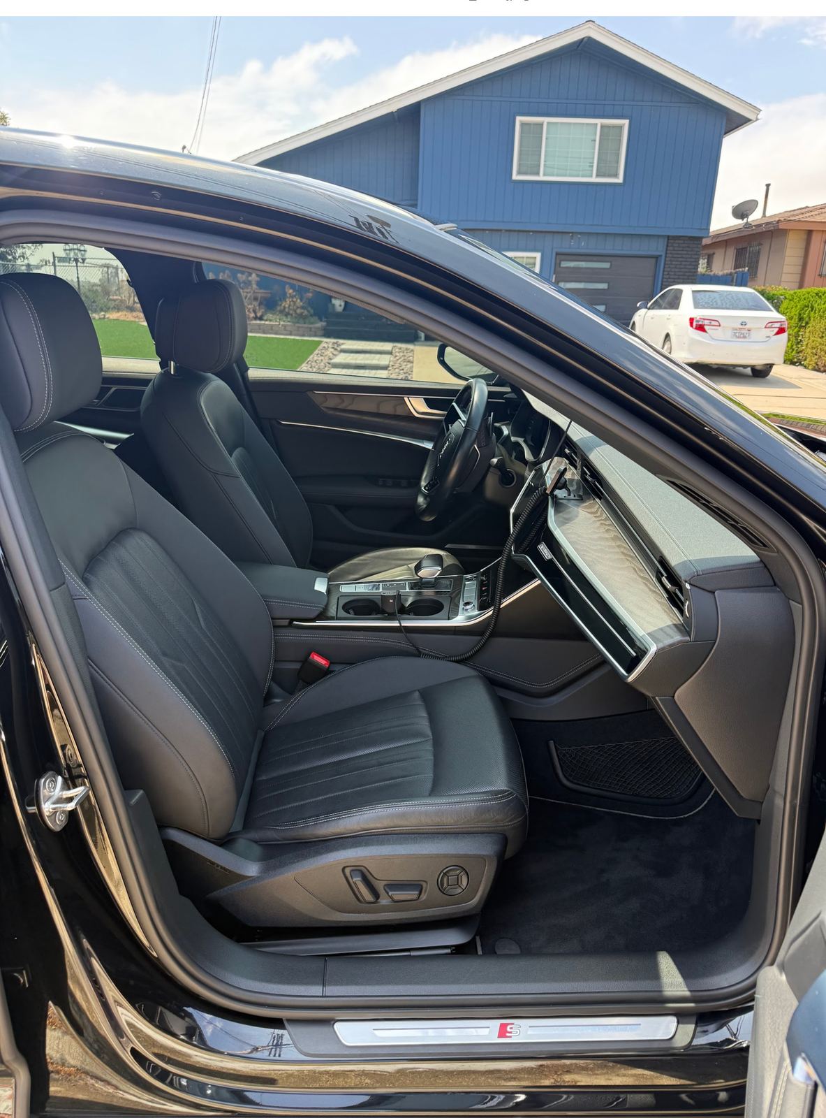 Detailed black Audi A6 front seats and dashboard, mobile detailing