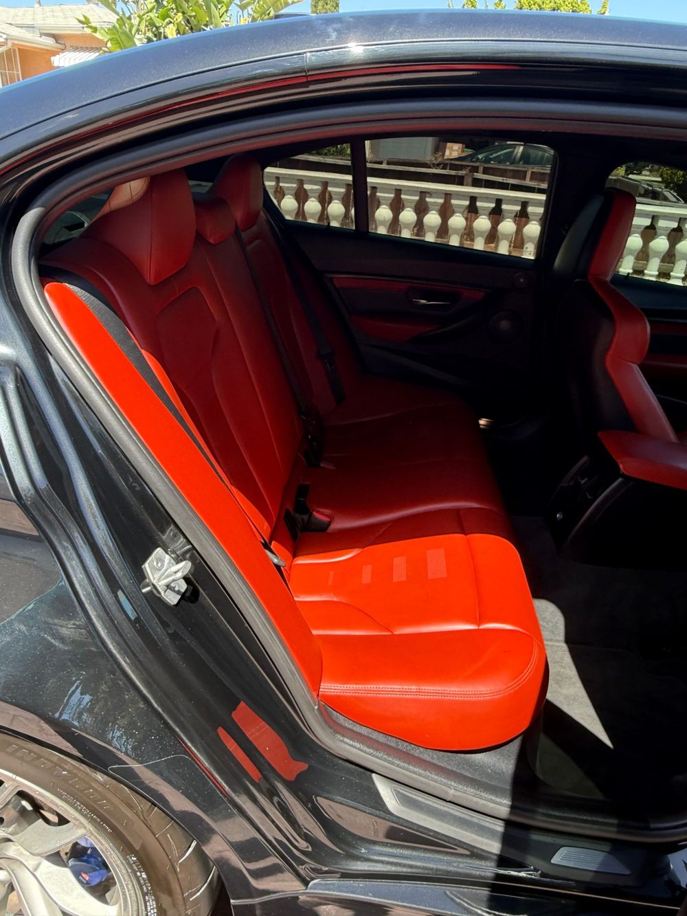Detailed BMW red and black rear seats, mobile detailing