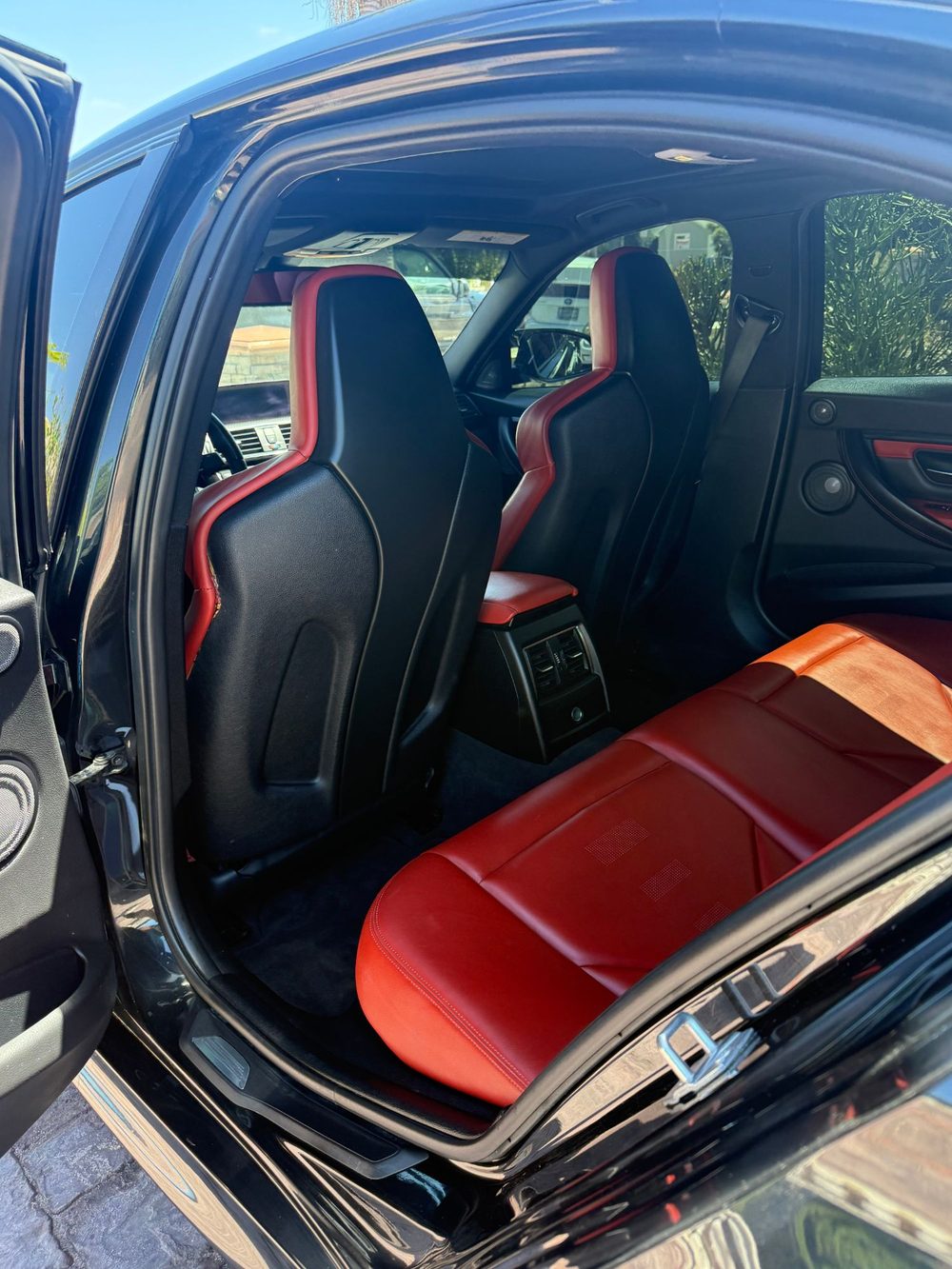Detailed BMW red and black front and rear seats, mobile detailing