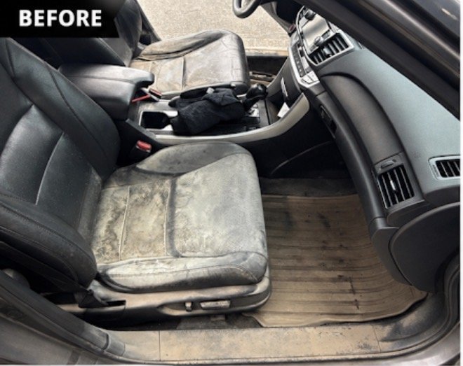 Front seat before detailing — worn, dirty leather and floor mats
